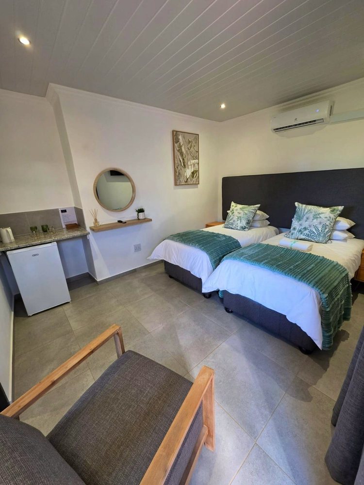 Room 2, two beds with a fridge, tea station and armchair